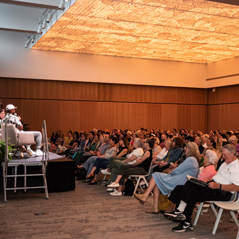 Visitors attending lecture in event center room