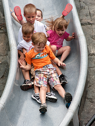 Children slide down spelunkers slide