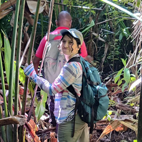 Researcher exploring tropical rainforest rich with plants