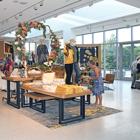 Woman shopping apparel in open, airy shop