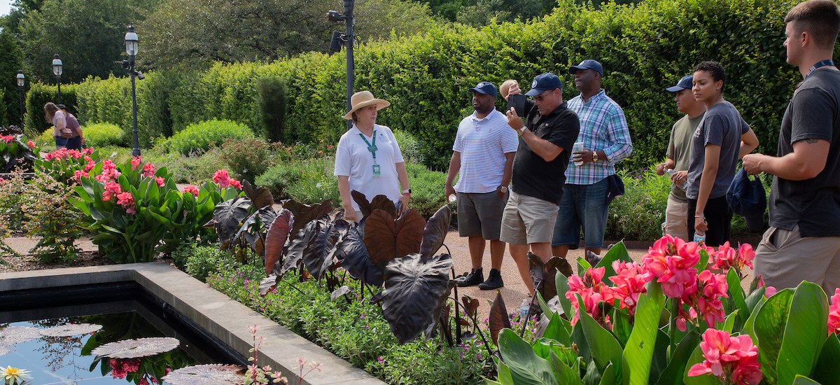 A Garden docent leads a tour of the Swift Family Garden amid colorful spring blooms